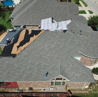 A beautiful drone picture showing a house getting it's roof replaced after hail hit this past summer.
