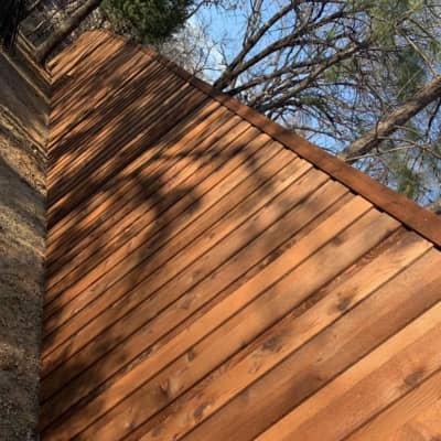 This is a side view of a fence completed and stained with fence stain in Corinth.