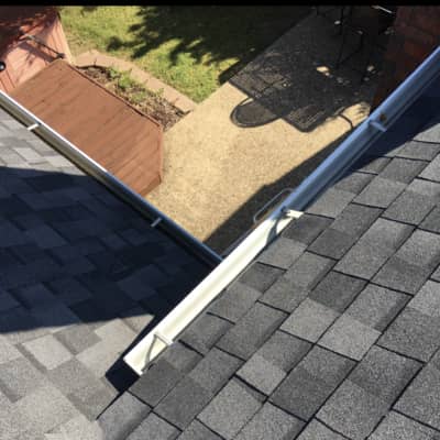 This picture shows a great job of installing both shingles and gutters.