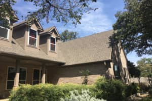This picture shows the side slope of a roof replacement in Denton Tx. We also completed their gutters and installed them for this homeowner.