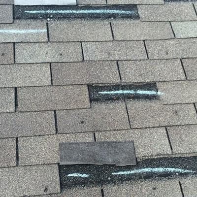 These shingles have both hail damage and wind damage from the hail storm that hit.